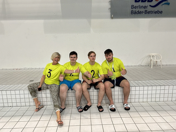 Schüler posieren mit der Schulleitung Birgit Wiechmann-Doil am Beckenrand